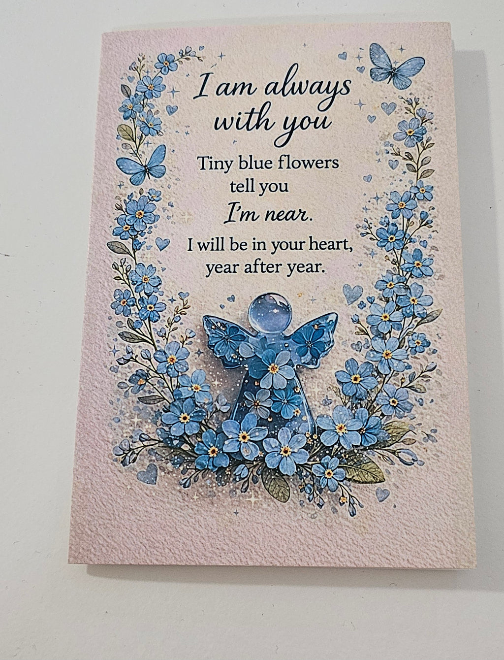 Condolence card with forget-me-not pin and tag